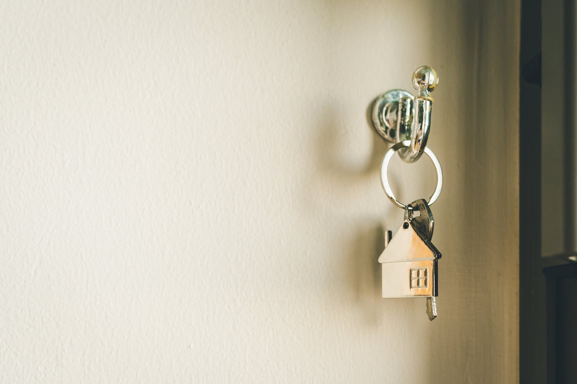 House model and key in house door. Real estate agent offer house, property insurance and security, affordable housing concepts